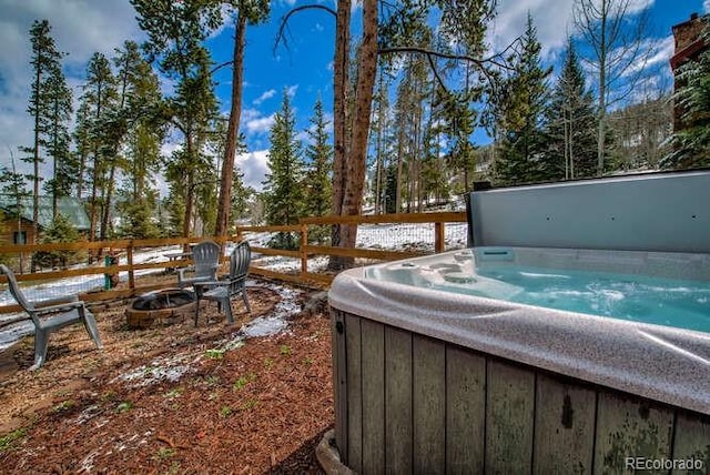 view of yard featuring a hot tub and a fire pit
