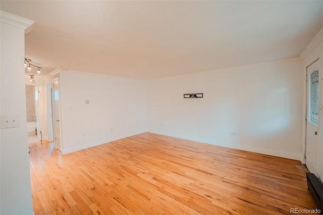 558 N Washington St Unit 103, Denver, CO 80203 - spare room featuring ornamental molding and light wood-type flooring