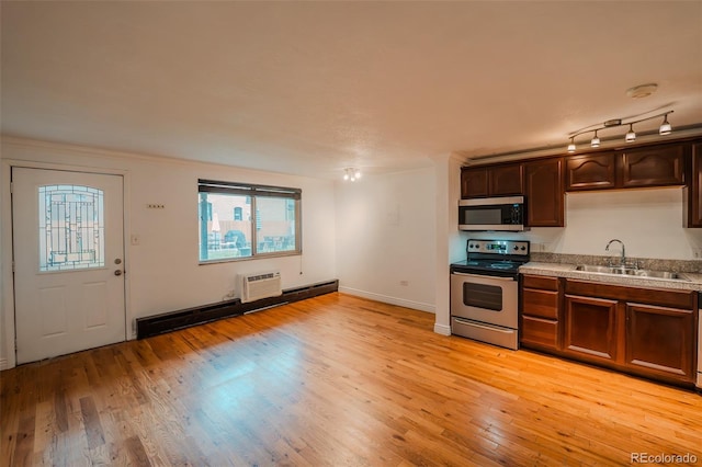 558 N Washington St Unit 103, Denver, CO 80203 - kitchen with stainless steel appliances, light wood-style flooring, light countertops, and dark brown cabinets