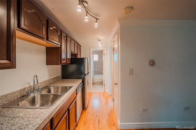 558 N Washington St Unit 103, Denver, CO 80203 - kitchen featuring light wood-style floors, stainless steel appliances, light countertops, and dark brown cabinetry