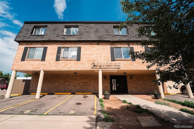 558 N Washington St Unit 103, Denver, CO 80203 - townhome / multi-family property featuring brick siding, uncovered parking, and mansard roof
