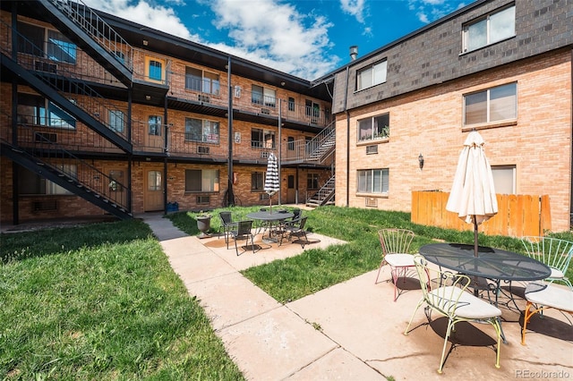 558 N Washington St Unit 103, Denver, CO 80203 - view of patio featuring stairway and outdoor dining area