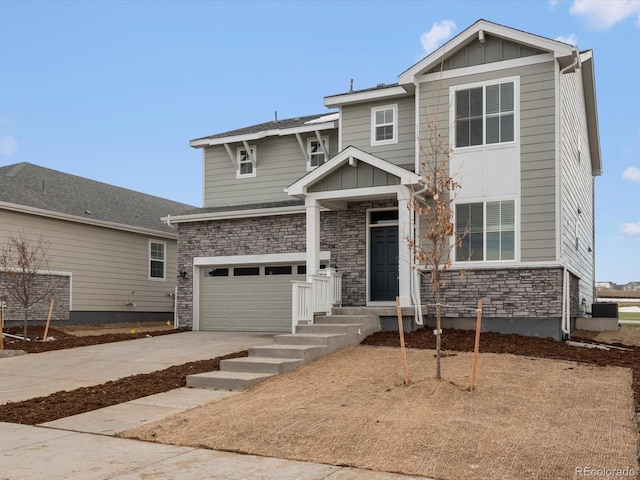 view of front of house featuring cooling unit, an attached garage, concrete driveway, stone siding, and board and batten siding