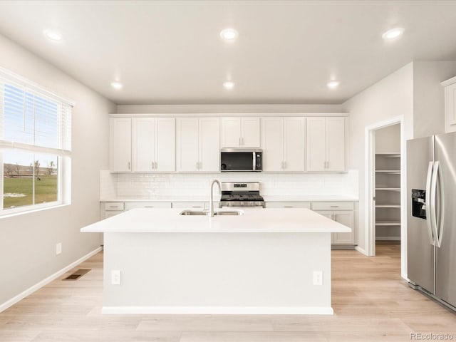 kitchen with a sink, visible vents, appliances with stainless steel finishes, and light countertops