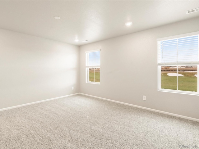 spare room featuring recessed lighting, visible vents, baseboards, and carpet flooring