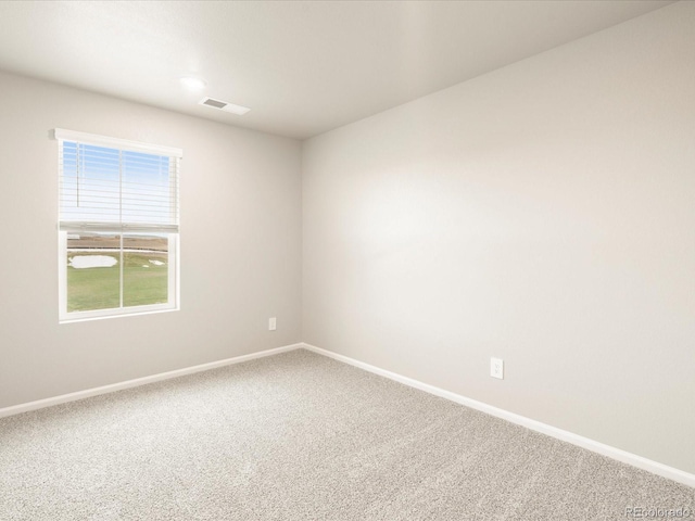 carpeted empty room featuring visible vents and baseboards