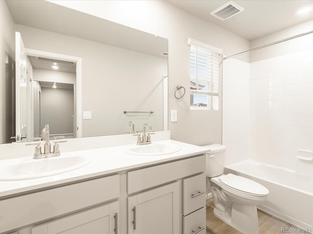 full bathroom featuring double vanity, visible vents, toilet, and a sink