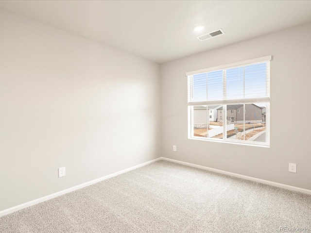 spare room with visible vents, baseboards, and carpet