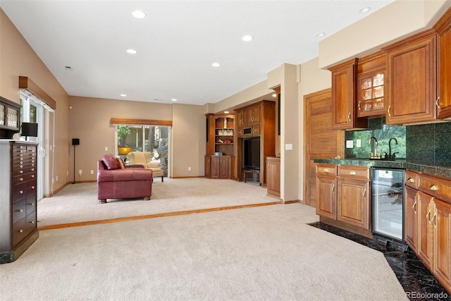 5120 Langdale Way, Colorado Springs, CO 80906 - kitchen with wine cooler, brown cabinetry, recessed lighting, light carpet, and open floor plan