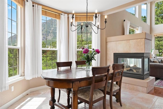 5120 Langdale Way, Colorado Springs, CO 80906 - dining space with a chandelier and a tiled fireplace