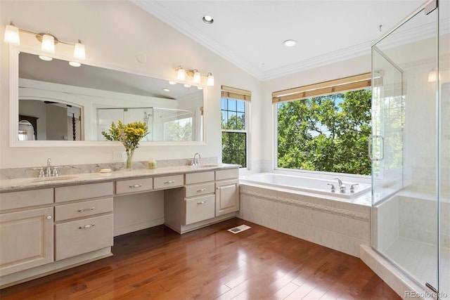 5120 Langdale Way, Colorado Springs, CO 80906 - full bathroom featuring double vanity, a garden tub, wood-type flooring, crown molding, and a shower stall