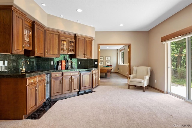 5120 Langdale Way, Colorado Springs, CO 80906 - kitchen featuring brown cabinets, plenty of natural light, glass insert cabinets, recessed lighting, and backsplash