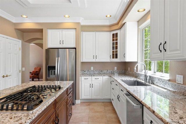 5120 Langdale Way, Colorado Springs, CO 80906 - kitchen featuring stainless steel appliances, plenty of natural light, ornamental molding, glass insert cabinets, and light stone countertops