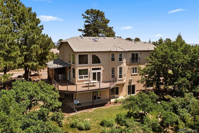 5120 Langdale Way, Colorado Springs, CO 80906 - rear view of property featuring stucco siding, a deck, and a tiled roof
