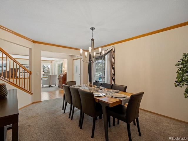 dining room featuring ornamental molding, carpet, and an inviting chandelier