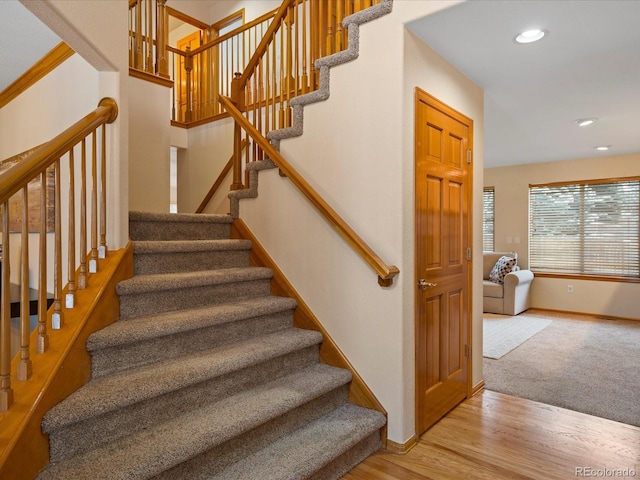 staircase with hardwood / wood-style floors