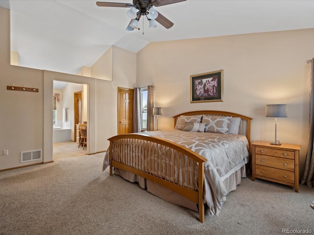 carpeted bedroom featuring connected bathroom, vaulted ceiling, and ceiling fan