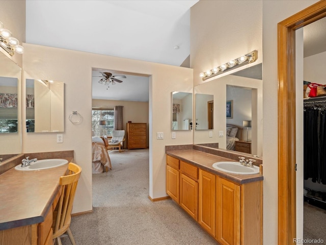 bathroom with vanity, vaulted ceiling, and ceiling fan