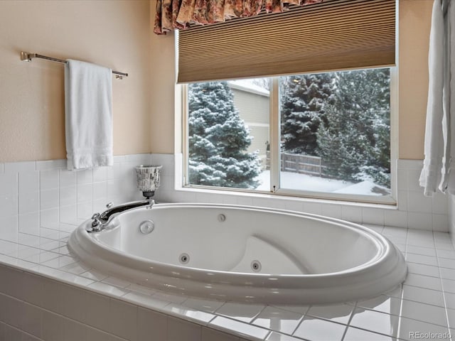 bathroom featuring tile patterned flooring and tiled bath