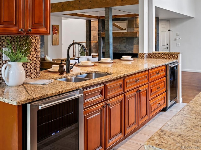 5884 S Hanover Way, Greenwood Village, CO 80111 - kitchen featuring beverage cooler, a sink, and light stone counters