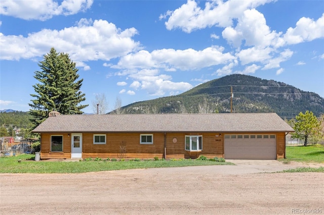 26063 Morris Ave, Conifer, CO 80433 - ranch-style home with a mountain view, dirt driveway, and a garage