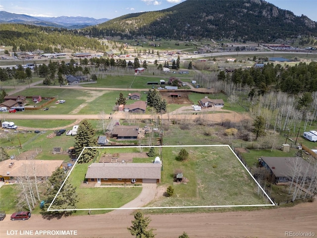 26063 Morris Ave, Conifer, CO 80433 - aerial view of property and surrounding area with property parcel outlined and a mountainous background