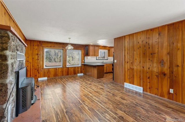 26063 Morris Ave, Conifer, CO 80433 - unfurnished living room with wood finished floors, wooden walls, and baseboards