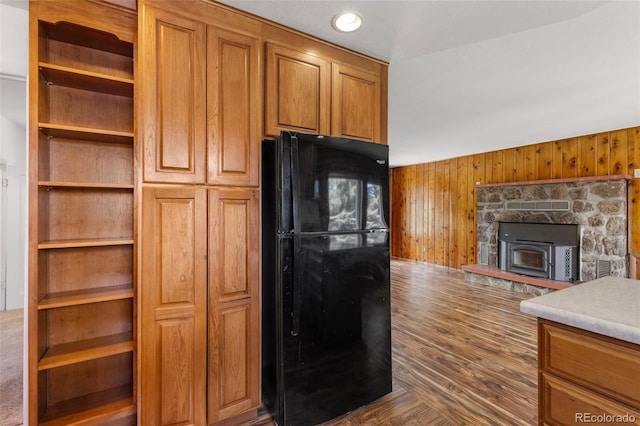 26063 Morris Ave, Conifer, CO 80433 - kitchen with freestanding refrigerator, wooden walls, brown cabinets, and light countertops