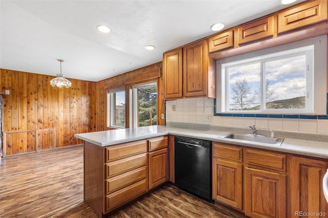26063 Morris Ave, Conifer, CO 80433 - kitchen featuring dishwasher, a sink, a peninsula, brown cabinets, and tasteful backsplash