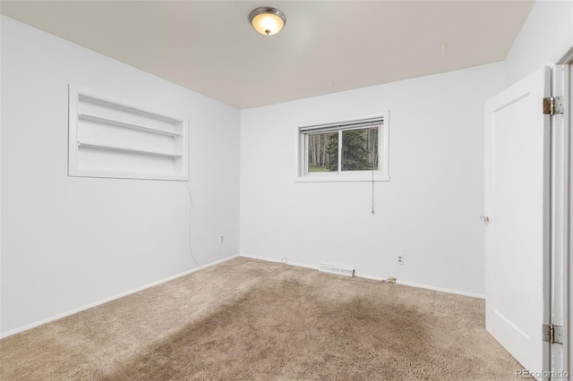 26063 Morris Ave, Conifer, CO 80433 - carpeted empty room featuring built in shelves and baseboards