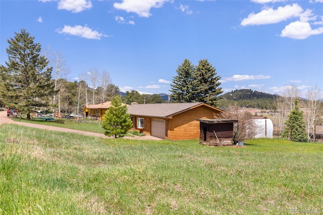 26063 Morris Ave, Conifer, CO 80433 - view of property exterior with concrete driveway, a yard, and an attached garage