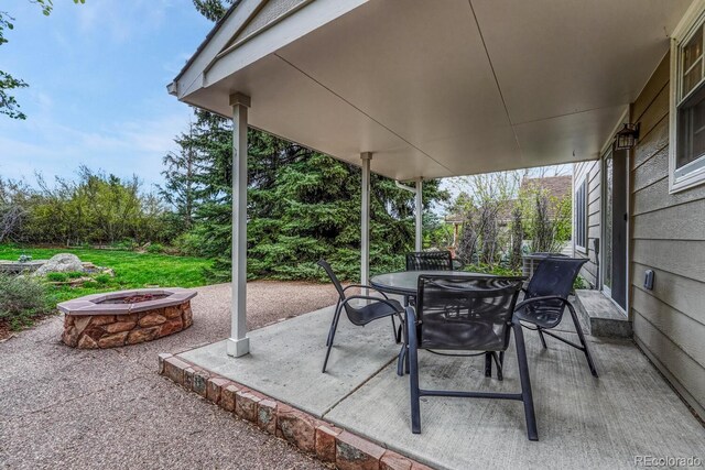 7100 S Hudson Cir, Centennial, CO 80122 - view of patio with outdoor dining area and an outdoor fire pit