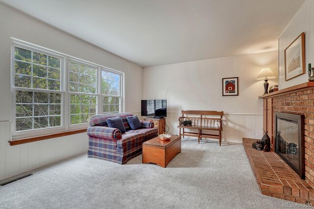 7100 S Hudson Cir, Centennial, CO 80122 - living area with carpet floors, visible vents, wainscoting, and a brick fireplace
