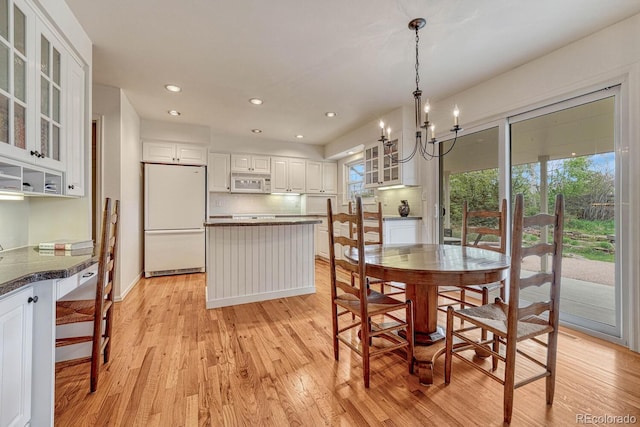 7100 S Hudson Cir, Centennial, CO 80122 - dining area featuring recessed lighting, light wood finished floors, baseboards, and a chandelier