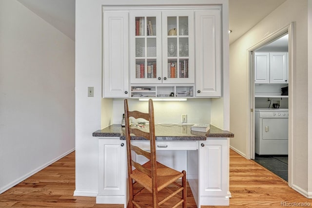 7100 S Hudson Cir, Centennial, CO 80122 - bar with baseboards, washer / dryer, and light wood-style floors