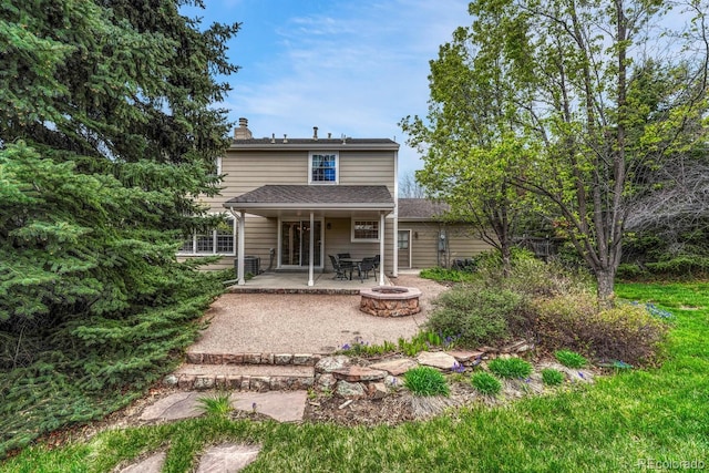 7100 S Hudson Cir, Centennial, CO 80122 - back of house featuring an outdoor fire pit, a patio area, and a chimney