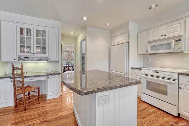 7100 S Hudson Cir, Centennial, CO 80122 - kitchen with light wood-style floors, white cabinets, and white appliances