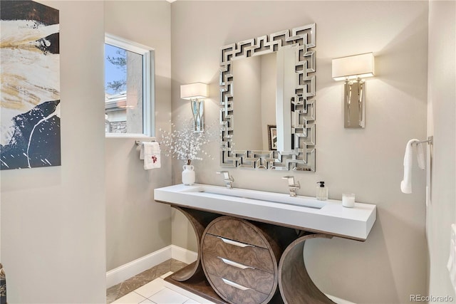 bathroom featuring baseboards and tile patterned floors