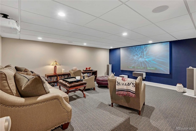 carpeted cinema with a drop ceiling, baseboards, and recessed lighting