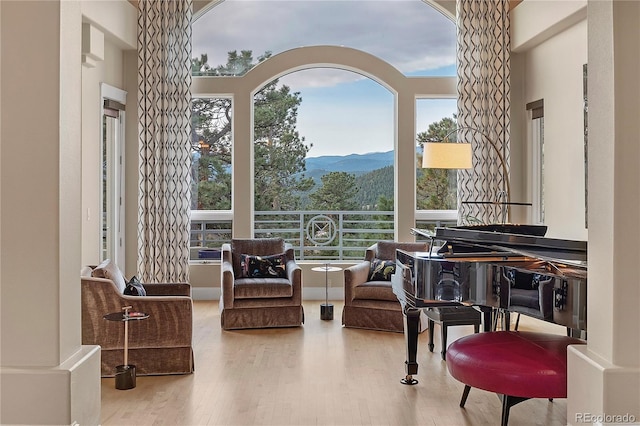 814 Neville Ln, Golden, CO 80401 - sitting room featuring wood finished floors, a mountain view, plenty of natural light, and ornate columns