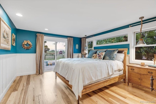 bedroom featuring hardwood / wood-style floors and access to outside