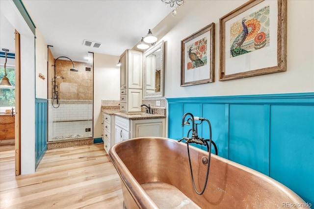 bathroom with vanity, hardwood / wood-style floors, and shower with separate bathtub