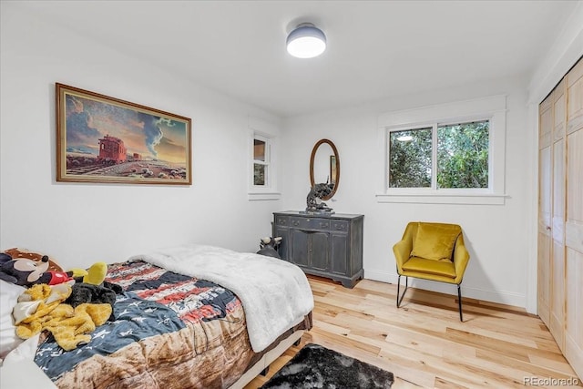 bedroom with a closet and light wood-type flooring