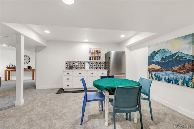 dining area featuring light carpet