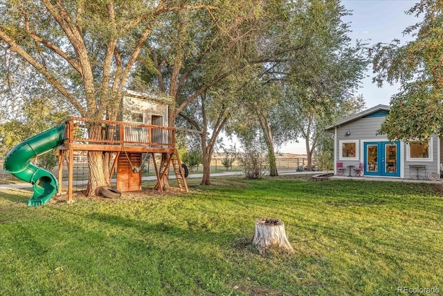 view of yard with french doors and a playground