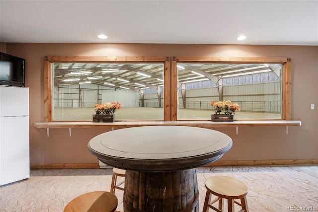 dining room with baseboards and recessed lighting