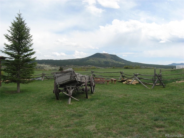view of yard with a mountain view, a rural view, and fence