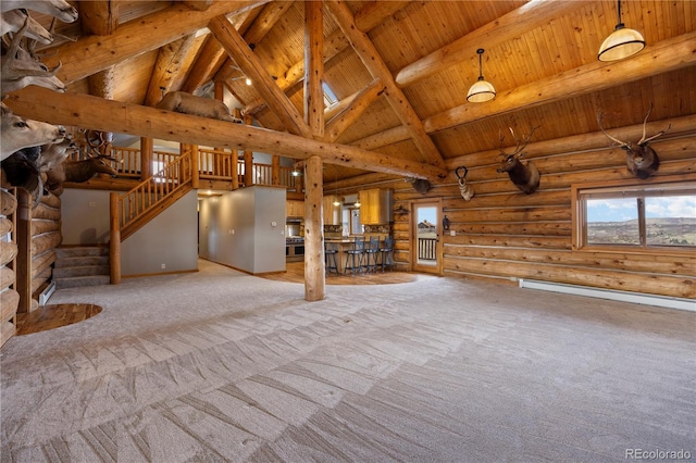 unfurnished living room with carpet, high vaulted ceiling, log walls, wooden ceiling, and beamed ceiling