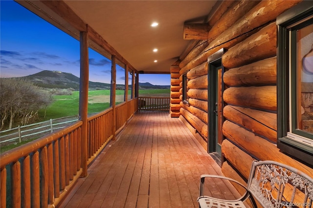 deck at dusk featuring a mountain view