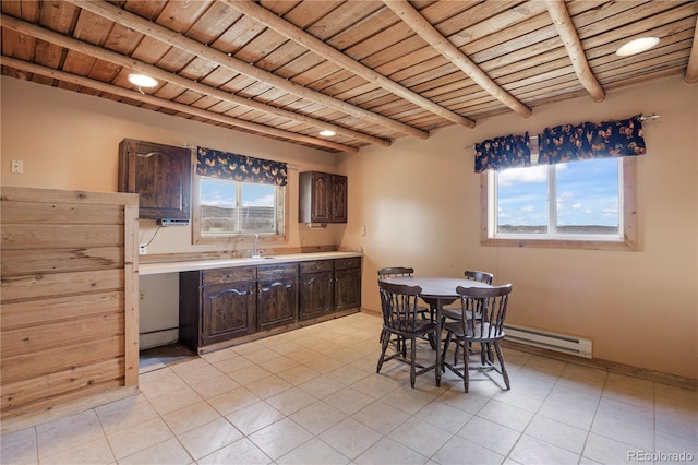 dining room featuring light tile patterned floors, wood ceiling, baseboard heating, and beamed ceiling
